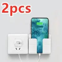 White punch-free sticky mobile phone charging storage rack holding a phone with charging cable plugged in, shown in pairs