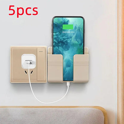 Mobile phone charging storage rack in beige with punch-free sticky mount holding phone next to wall outlet