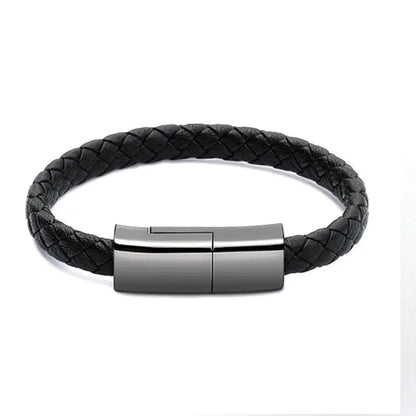 Black braided leather bracelet charger with sleek metallic USB charging clasp closed on white background