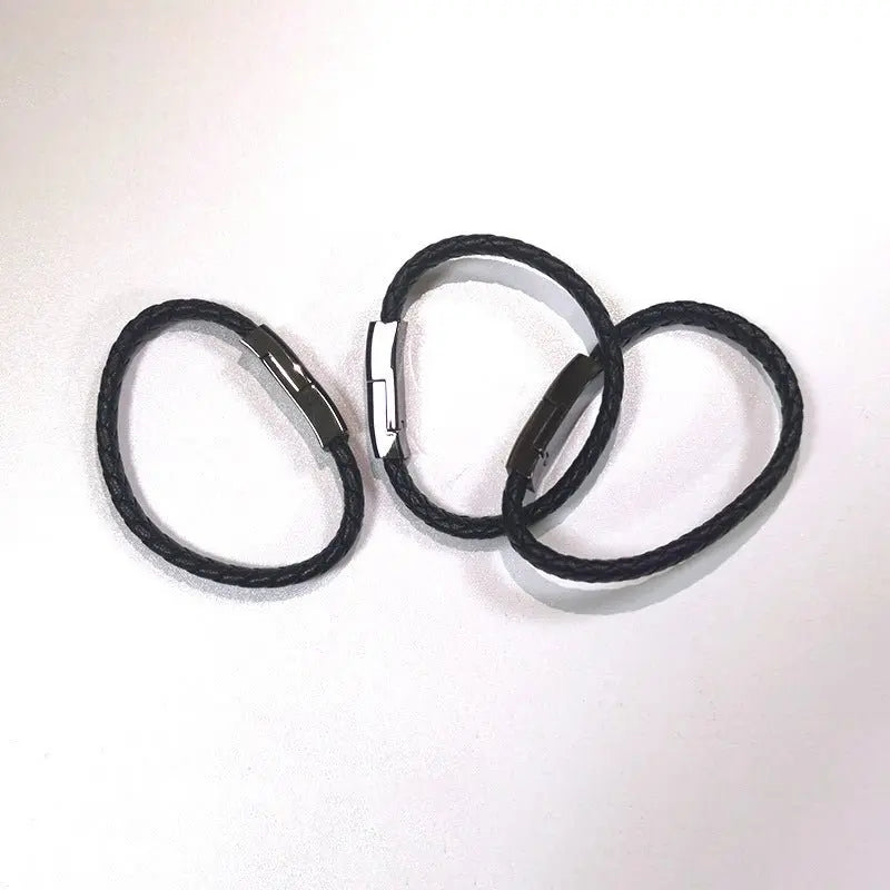 Three black braided leather bracelet chargers with metal USB charging connectors on a white background