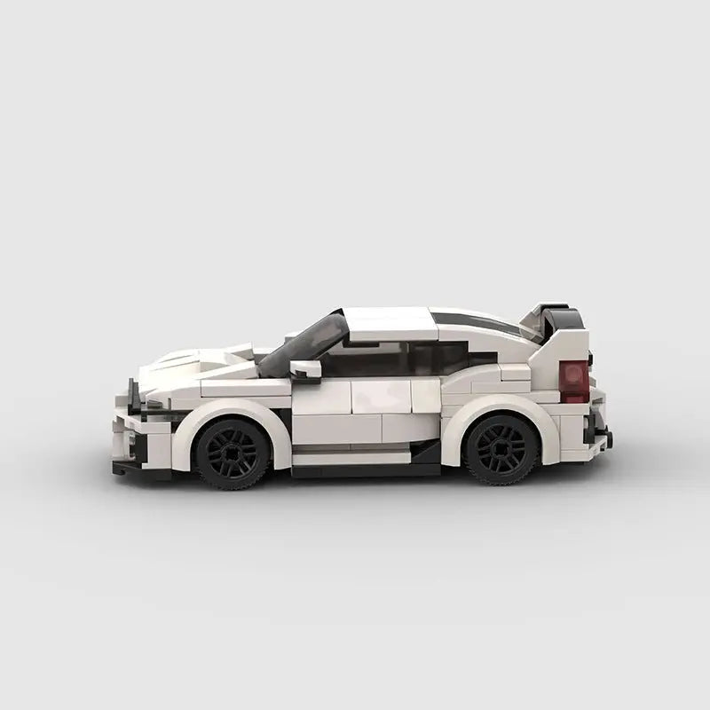 Side view of white high-tech building block plastic toy car with black wheels and rear spoiler on light background
