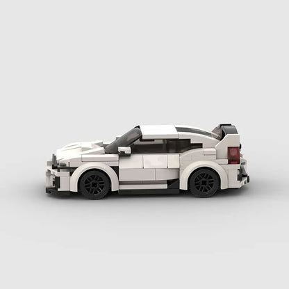 Side view of white high-tech building block plastic toy car with black wheels and rear spoiler on light background