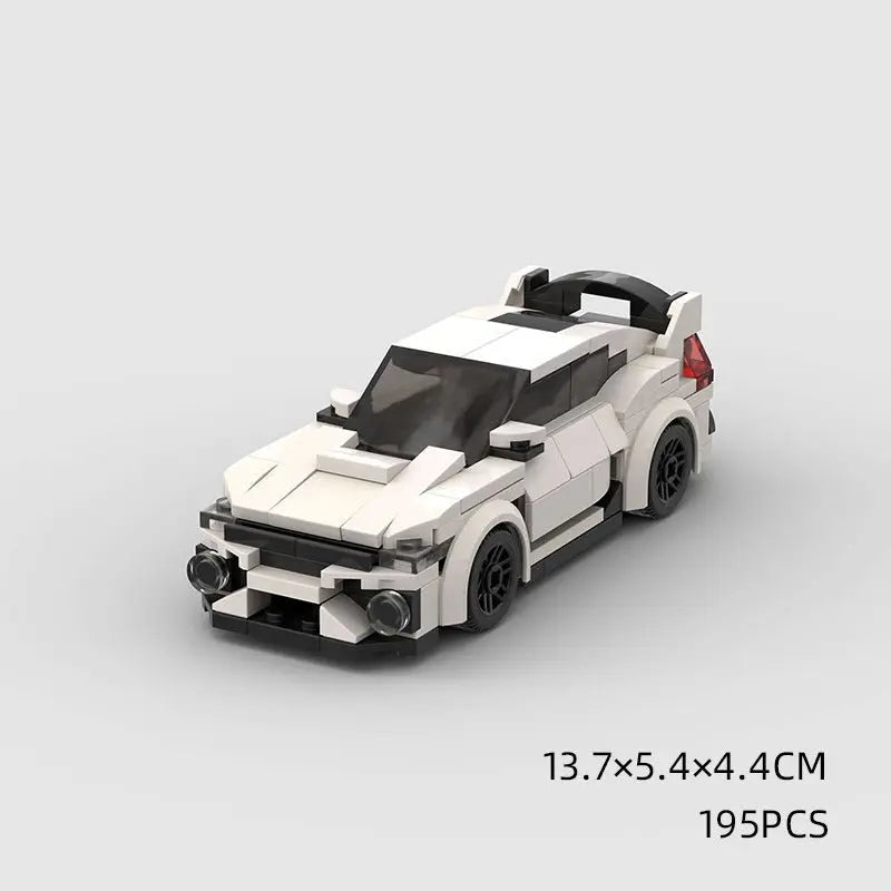 White high-tech building block toy car with black wheels and detailed front and rear design on gray background