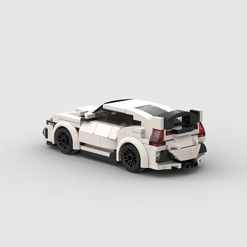 Rear view of white and black high-tech building block plastic toy car with rear spoiler and detailed design