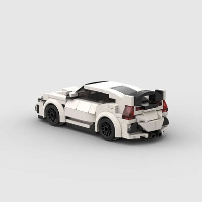 Rear view of white and black high-tech building block plastic toy car with rear spoiler and detailed design