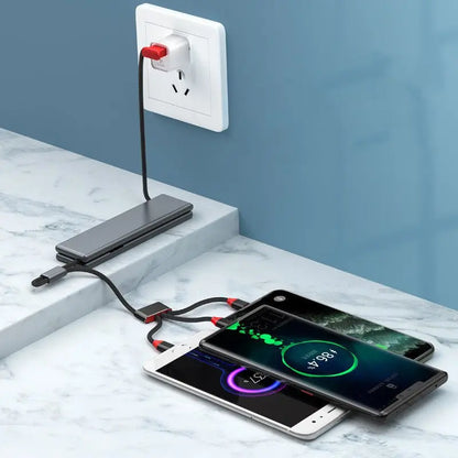 Portable multifunctional one-for-three charger in black connected to power outlet charging three smartphones on marble surface