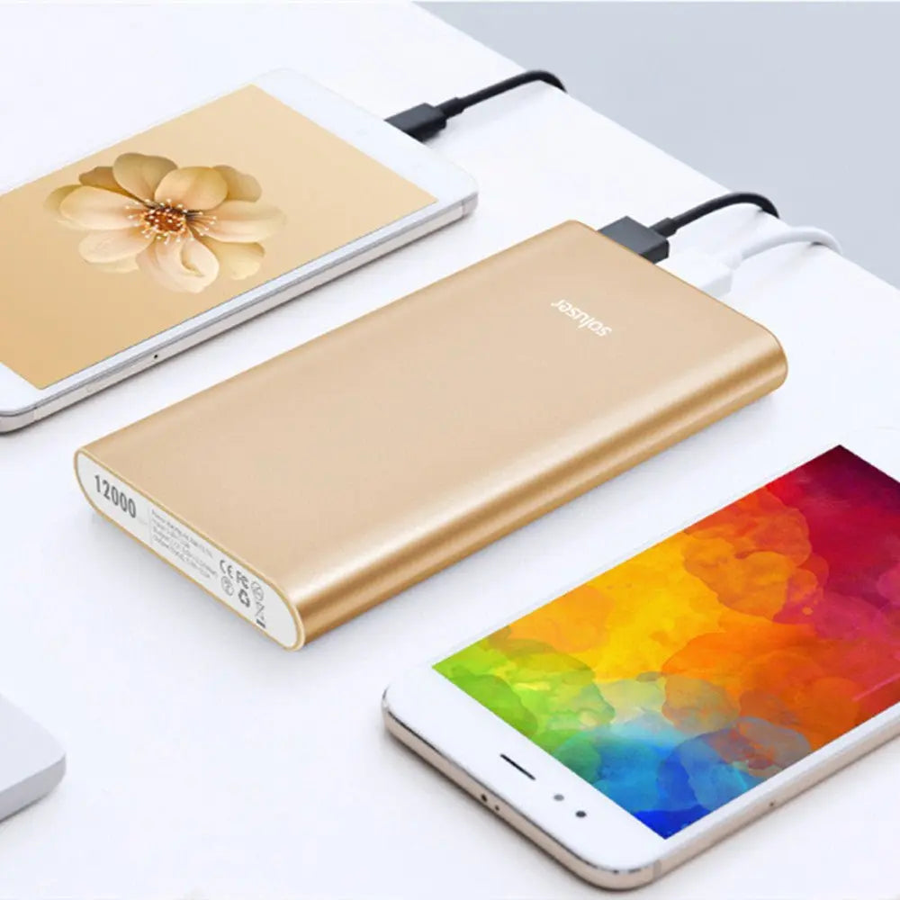 Gold ultra-thin aluminum alloy power bank 12000mAh charging two white smartphones simultaneously on white surface