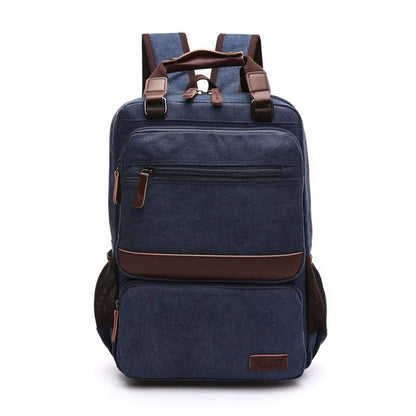 Front view of navy blue canvas laptop backpack with brown leather accents and multiple zippered compartments