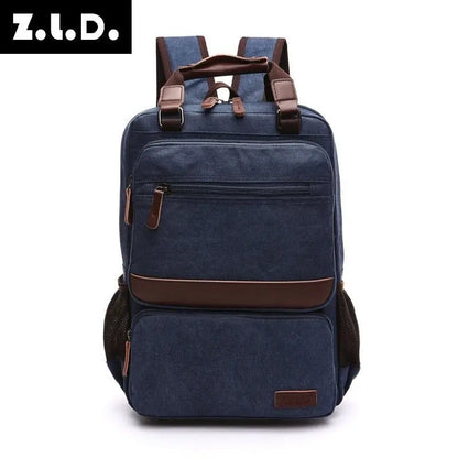 Front view of navy blue canvas laptop backpack with brown leather accents and multiple zippered compartments