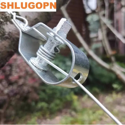 Close-up of galvanized steel wire tensioner clamp with tightening bolt holding metallic rope in outdoor setting
