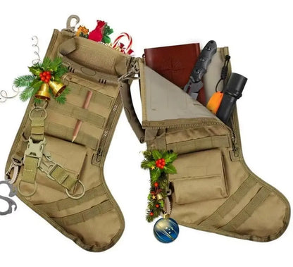 Pair of tan tactical MOLLE Christmas stockings with outdoor gear and festive holiday decorations