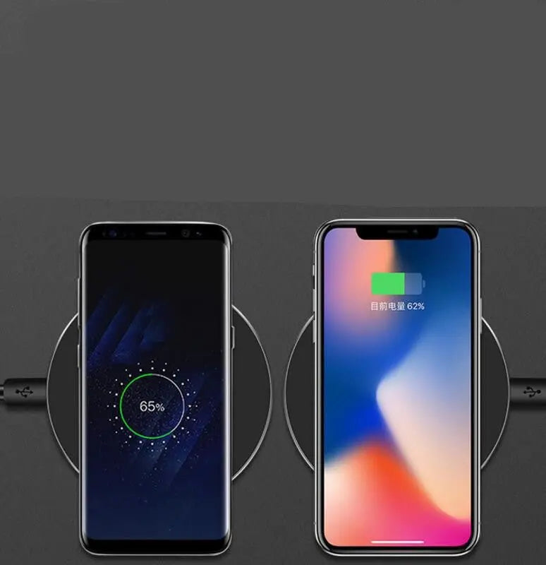 Top view of black fast wireless charging pad charging Samsung and iPhone smartphones side by side
